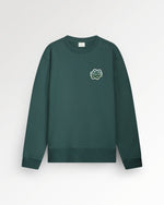 A green sweatshirt with a small graphic on the upper left side.